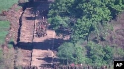 In this undated photo provided on June 18, 2024 by South Korea Defense Ministry, North Korean soldiers work at an undisclosed location near the border area, as seen from a South Korean guard area. (South Korea Defense Ministry via AP)