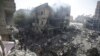 FILE - Palestinians look at the aftermath of the Israeli bombing in Nuseirat refugee camp, Gaza Strip, on June 8, 2024. The U.N. human rights office is citing possible war crimes by Israeli forces and Hamas in connection with a raid that freed four hostages over the weekend. 