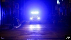 ARCHIVO - Un coche de policía patrulla para informar a la gente sobre la ubicación de las zonas de seguridad después de una fuerte réplica en Arica, Chile, la madrugada del jueves 3 de abril de 2014.