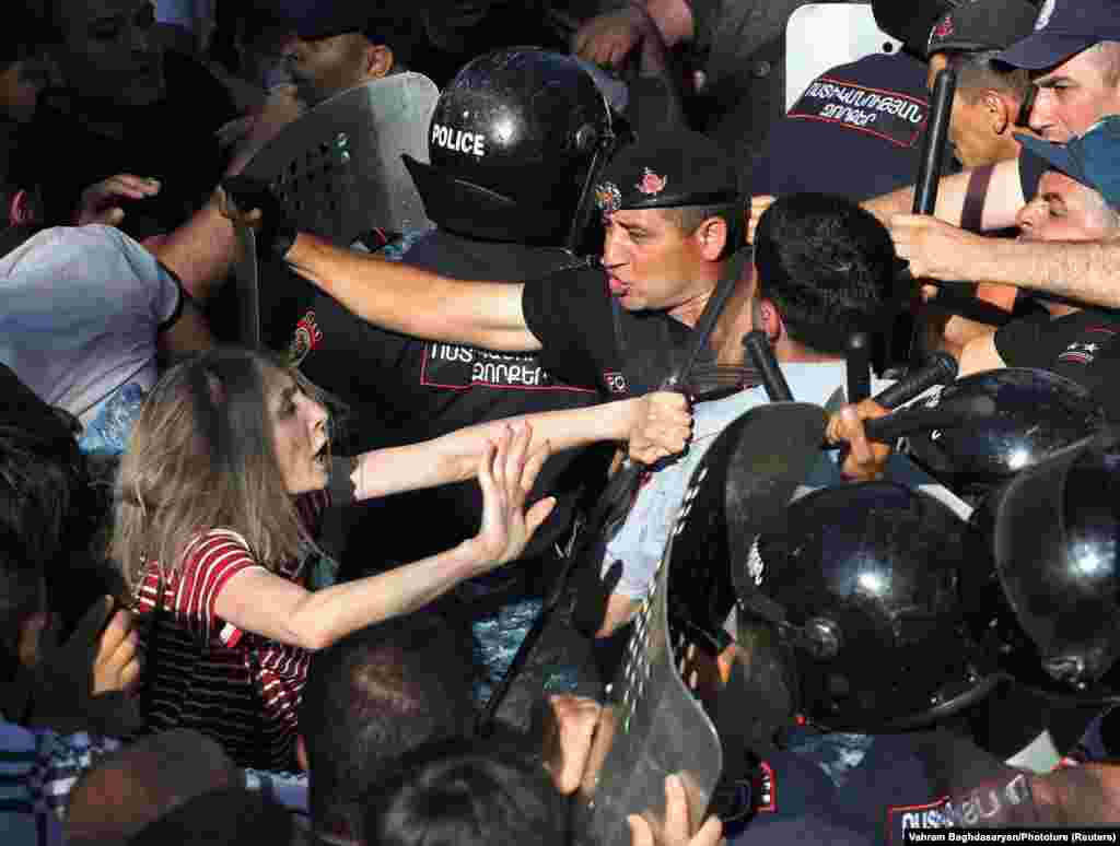 Demonstrators scuffle with law enforcement officers during a protest against Armenian Prime Minister Nikol Pashinyan near the building of the National Assembly in Yerevan.