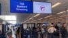 FILE - A sign warns travelers not to bring guns through the Transportation Security Administration checkpoint at Orlando International Airport in Orlando, Florida, April 23, 2022.