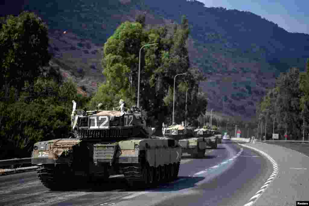 A convoy of Israeli military vehicles are seen on a road close to Israel's border with Lebanon in northern Israel, Oct. 8, 2023.