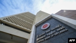 Central Bank of Sri Lanka logo is pictured on the building facade of its head office in Colombo. (Photo by Ishara S. KODIKARA / AFP)