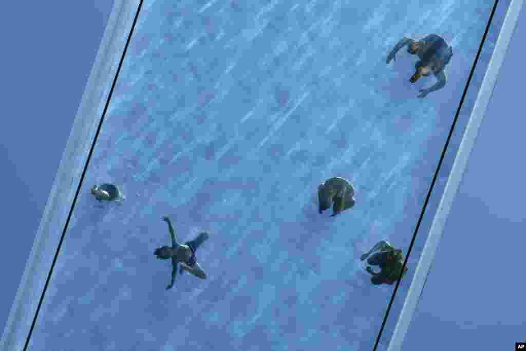 Swimmers and sun bathers enjoy the Sky Pool in London, July 30, 2024.