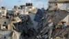 Palestinians inspect the site of an Israeli strike on a house, amid the ongoing conflict between Israel and the Palestinian Islamist group Hamas, in Rafah, in the southern Gaza Strip, May 7, 2024. 