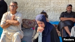 Mourners react next to the bodies of Palestinians (not pictured) killed in an Israeli strike, in Deir Al-Balah in central Gaza Strip, May 24, 2024.
