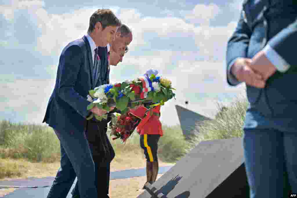 France's Prime Minister Gabriel Attal (L), Britain's Prince William, the Prince of Wales (C) and Canadian Prime Minister Justin Trudeau (R) lay a wreath during the Canadian commemorative ceremony marking the 80th anniversary of the World War II "D-Day" Allied landings in Normandy, at the Juno Beach Centre near the village of Courseulles-sur-Mer, in northwestern France, June 6, 2024. 