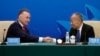 Australia's former Trade Minister Craig Emerson and China's former Foreign Minister Li Zhaoxing shake hands at the China-Australia High Level Dialogue in Beijing, Sept. 7, 2023. Australian Prime Minister Anthony Albanese's coming visit to China is a sign of improving relations. 