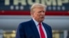 FILE - Former President Donald Trump speaks with reporters before departure from Hartsfield-Jackson Atlanta International Airport, Aug. 24, 2023, in Atlanta. 