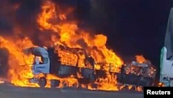 Smoke rises as a truck burns near the Myanmar-China border, near Muse, Myanmar, in this screen grab obtained from a social media video released on Nov. 23, 2023. 