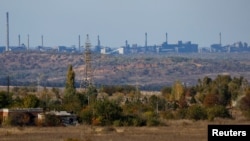 A view shows the Avdiivka Coke and Chemical Plant in the town of Avdiivka as seen from Yasynuvata (Yasinovataya) in the Donetsk region, Russian-controlled Ukraine, Oct. 18, 2023.