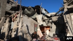 A Palestinian man checks the rubble of a building following Israeli bombardment on Jan. 18, 2024, in Rafah in the southern Gaza Strip.