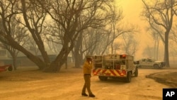 In this photo provided by the Flower Mound, Texas, Fire Department, Flower Mound firefighters respond to a fire in the Texas Panhandle, Feb. 27, 2024. (Flower Mound Fire Department via AP)