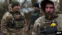 Ukrainian servicemen take a break on the frontline near the town of Bakhmut, Donetsk region, on Nov. 18, 2023, amid the Russian invasion of Ukraine.