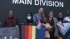 ARCHIVES - Des activistes LGBTQI entourent le couple homosexuel de Johan Potgieter (au centre) et Daniel Digashu devant la Haute Cour de Windhoek, en Namibie, le 20 janvier 2022.