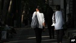Iranian women not wearing their mandatory headscarves, or hijab, walk in Tehran, Iran, Aug. 5, 2023. 