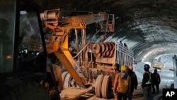 This photo provided by Uttarakhand State Disaster Response Force (SDRF) shows rescue work inside a collapsed road tunnel where 40 workers were trapped in northern in Uttarakhand state, India, Nov.14, 2023.