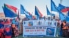FILE - Demonstrators in Mogadishu hold banners and flags in support of Somalia's government on Jan. 3, 2024, following the port deal signed between Ethiopia and the breakaway region of Somaliland.