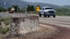 Mormon crickets make their way over a Jersey barrier during the migration of Mormon crickets, June 17, 2023, in Spring Creek, Nevada.