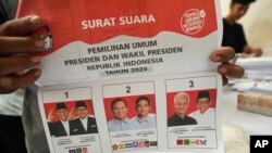 A worker holds a ballot for the February 14 presidential election showing candidates and their running mates, during the preparation for the distribution of election logistics in Tangerang, Indonesia, Jan. 10, 2024.