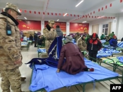 Local residents rest at a temporary shelter after a magnitude 7.1 earthquake strikes Wushi County, Aksu prefecture, in Chinas northwestern Xinjiang region, Jan. 23, 2024.