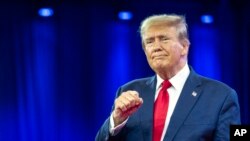 Republican presidential candidate former President Donald Trump pumps his fist as he departs after speaking during the Conservative Political Action Conference, CPAC 2024, in Oxon Hill, Md., Feb. 24, 2024.