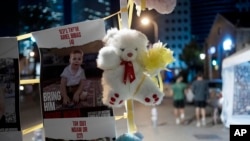 A poster showing Ariel Bibas, 4, who is held hostage along with his family by Hamas in the Gaza Strip, is displayed ahead of an anticipated hostage release, in Tel Aviv, Israel, Nov. 23, 2023.