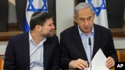 Israeli Prime Minister Benjamin Netanyahu, right, speaks with Minister of Finance Bezalel Smotrich during the weekly cabinet meeting at the Defense Ministry in Tel Aviv, Israel, Jan. 7, 2024.