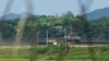 FILE - A North Korean military guard post, upper middle, and South Korean post, bottom, are seen from Paju, South Korea, near the border with North Korea, on Sept. 8, 2023.