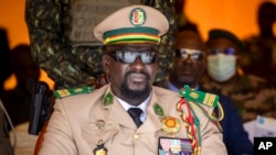 FILE - Guinea's junta leader Col. Mamady Doumbouya watches over an independence day military parade in Bamako, Mali, on Sept. 22, 2022. 