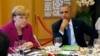 FILE - U.S. President Barack Obama (R) and German Chancellor Angela Merkel listen during the G7 Summit working dinner in Brussels.