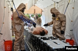 FILE - Members of the State Emergency Service attend nuclear disaster response drills amid shelling of Zaporizhzhia Nuclear Power Plant, in Zaporizhzhia, Ukraine August 17, 2022.