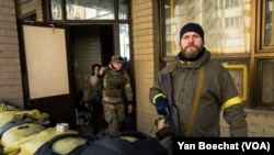 Civilians in Kyiv, Ukraine, arm themselves for battle with Russian forces with the support of their government, Feb. 25, 2022.