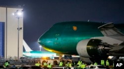 The final Boeing 747 built makes it way across the Boeing Freeway after rolling out of a factory hangar for the first time, Dec. 6, 2022, in Everett, Washington. 