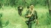Nate Thayer, walks along with the Khmer Rouge soldiers in the Khmer Rouge's controlled area in 1990. (Facebook/Nate Thayer)