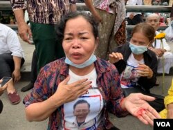អ្នកស្រី អ៊ុក ចន្ធី ភរិយារបស់​លោក យឹម សារ៉េត ដែល​ជា​សកម្ម​ជន​មួយ​រូប​ទើប​ត្រូវ​បាន​តុលាការ​កាត់​ទោស​និយាយទាំង​បាត​ដៃ​ឆ្វេង​មានហូរ​ឈាម​ដោយ​សារ​ការ​ចាប់​អូស​របស់​ក្រុម​សន្តិសុខ ប្រាប់​អ្នកសារព័ត៌មាន នៅ​ខាងមុខ​សា​លា​ដំបូង​រាជធានី​ភ្នំពេញ នៅ​ថ្ងៃទី​១៧ ខែមីនា ឆ្នាំ​២០២២។ (កាន់ វិច្ឆិកា/វីអូអេ)
