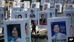 Candidates' posters for the upcoming general elections are hung on strings over the Cheonggye stream in downtown Seoul, South Korea, Monday, April 11, 2016.