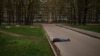 FILE - The body of a man killed during a Russian bombardment lies on a street in a residential neighborhood in Kharkiv, Ukraine, April 19, 2022.