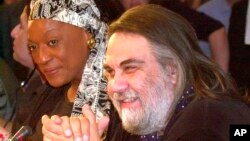FILE - Composer Vangelis, right, is pictured at a press conference in Athens, June 27, 2001. The Greece-born electronic composer who wrote the Academy Award-winning score for the film "Chariots of Fire" and music for dozens of other works died May 17, 2022, in France at age 79.