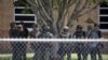 ARCHIVO - Agentes del orden están parados afuera de la Escuela Primaria Robb tras un tiroteo fatal el 24 de mayo del 2022 en Uvalde, Texas.