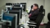 FILE - A workers sits at a computer at the Department of Homeland Security's National Cybersecurity and Communications Integration Center (NCCIC) in Arlington, Va., Aug. 22, 2018. 