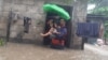This handout photo taken on Dec. 25, 2022 and received on December 26 from the Philippine Coast Guard shows rescuers evacuating a child from a flooded area in Ozamiz City, Misamis Occidental.