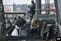 Ukrainian soldiers rest near their position in Bakhmut, Donetsk region, Ukraine, Dec. 17, 2022.
