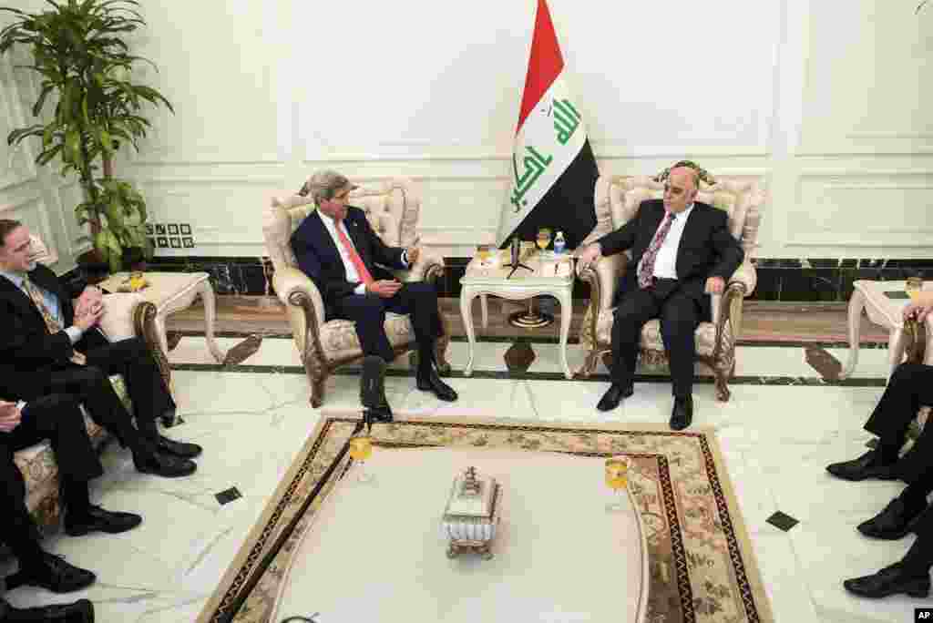 U.S. Secretary of State John Kerry, center left, speaks to new Iraqi Prime Minister Haider al-Abadi, center right, during a meeting in Baghdad, Iraq, Sept. 10, 2014.