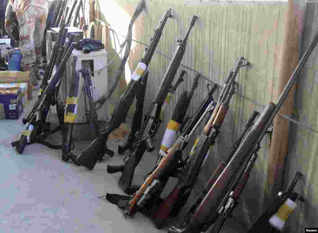 Weapons recovered during a raid by paramilitary forces on Muttahida Qaumi Movement (MQM) political party's headquarters are displayed for the media in Karachi, March 11, 2015.