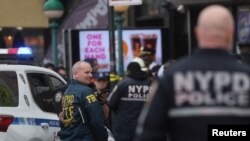 Law enforcement officers work near the scene of a shooting at a subway station in the Brooklyn borough of New York City, New York, U.S., April 12, 2022.