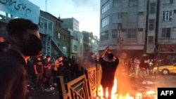 FILE - A picture obtained by AFP outside Iran on Sept. 21, 2022, shows Iranian demonstrators taking to the streets of the capital Tehran during a protest for Mahsa Amini, days after she died in police custody.