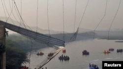 Rescuers search for survivors after a suspension bridge collapsed in Morbi town in the western state of Gujarat, India, Oct. 31, 2022. 
