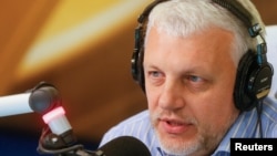 FILE - Journalist Pavel Sheremet talks on the air at a radio station in Kiev, Ukraine, October 11, 2015. 