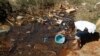 FILE - Residents fetch water from unprotected sources in Harare, Zimbabwe, July 28, 2012. The country is now dealing with another outbreak of typhoid fever.